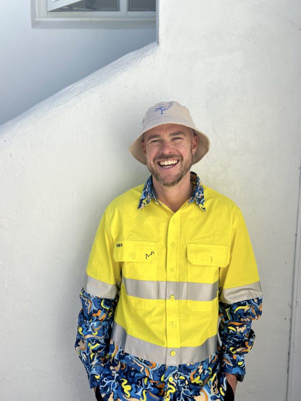 High vis yellow work shirt with custom Blue Tree pattern, a collaboration between Blue Tree Project and TradeMutt to support mental health awareness