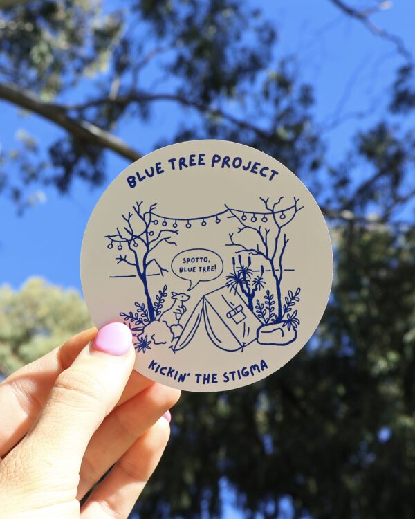A vibrant sticker depicting a kangaroo standing beside a tent under a sky filled with stylised blue trees in an Australian outback setting. The scene is designed to raise awareness for the Blue Tree Project, a mental health initiative that began in Western Australia and has grown into a global movement.